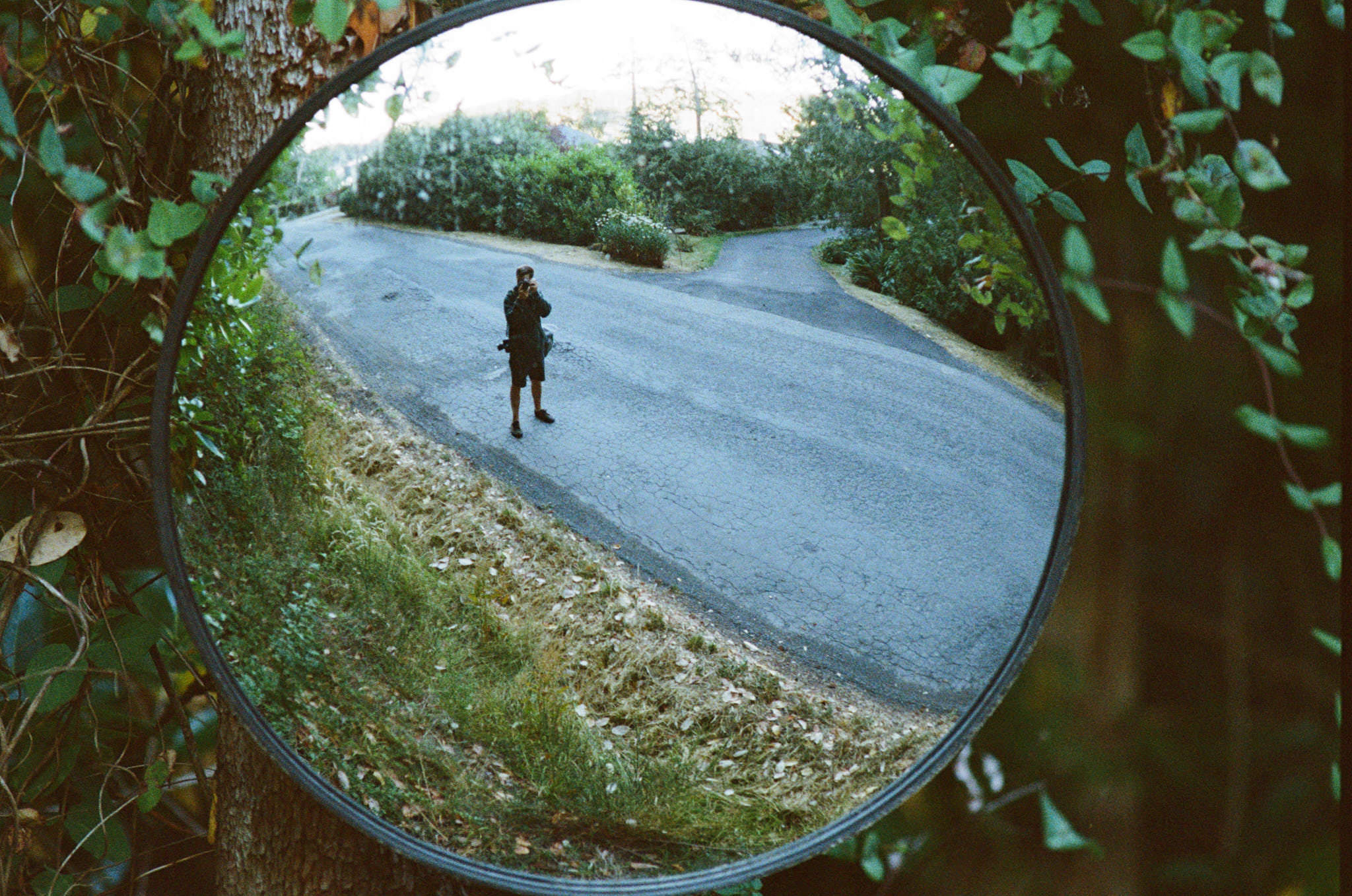 A person reflected in a roadside mirror, photographed by Dan Pearce